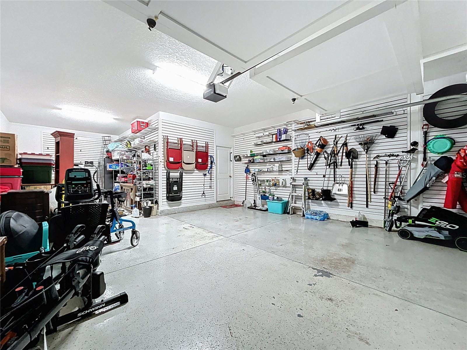 Garage Featuring Custom Wall Panels for Organized Tool and Item Storage