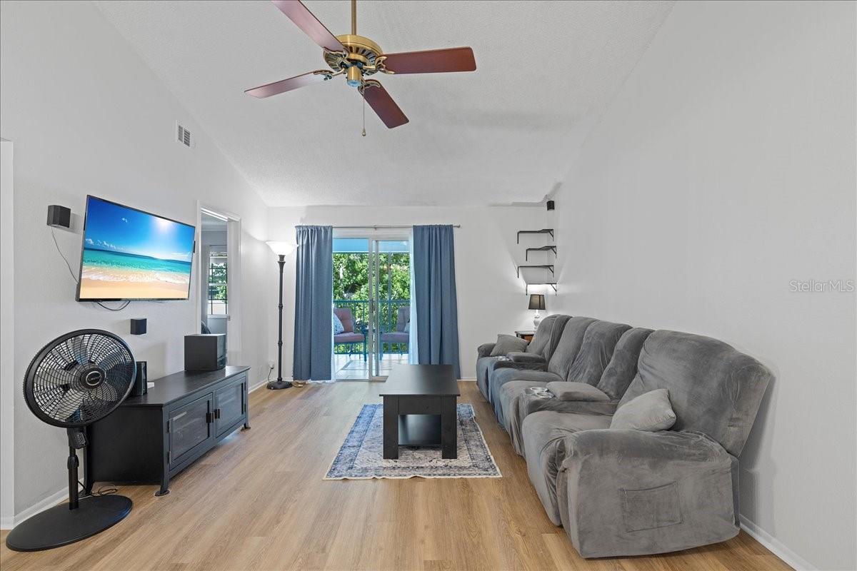 Living room with glass sliders out to balcony