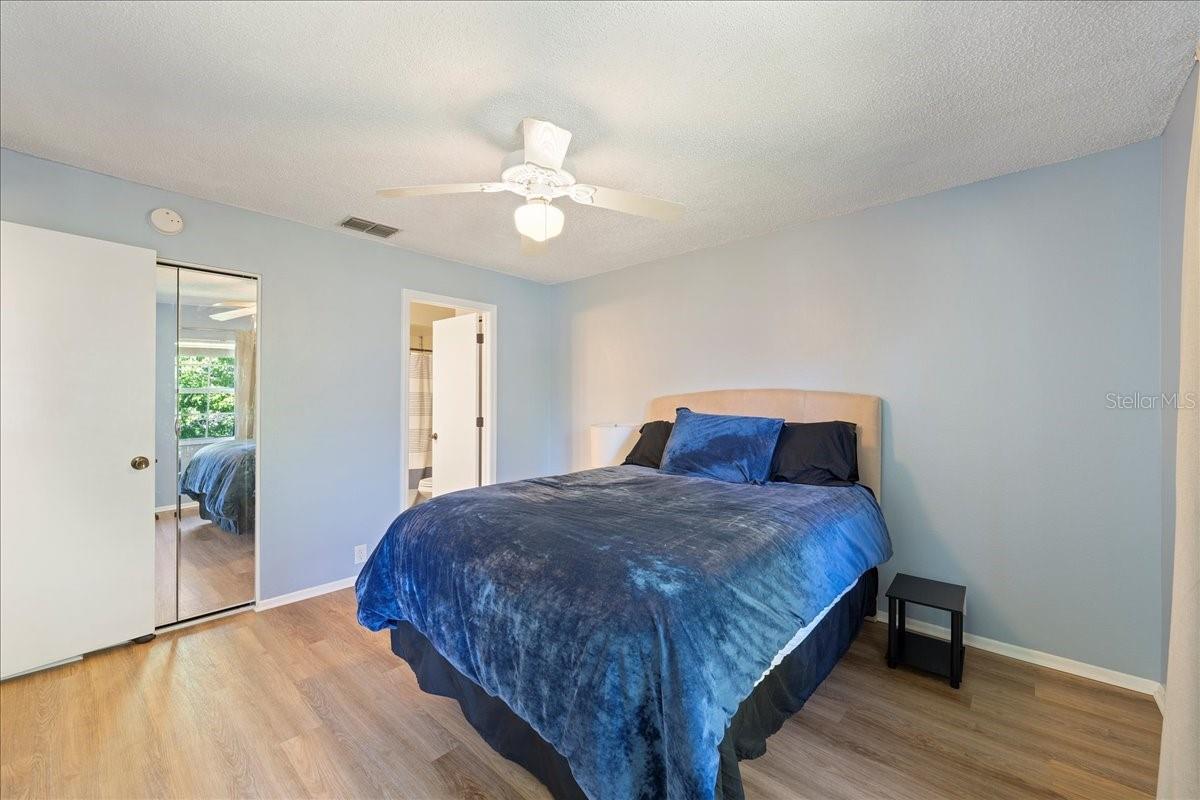 Primary Bedroom with glass sliders to balcony, ensuite bathroom and walk-in closet