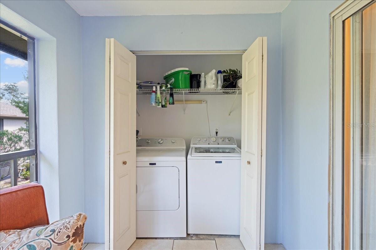 Balcony with access from living room and primary bedroom. Includes laundry closet