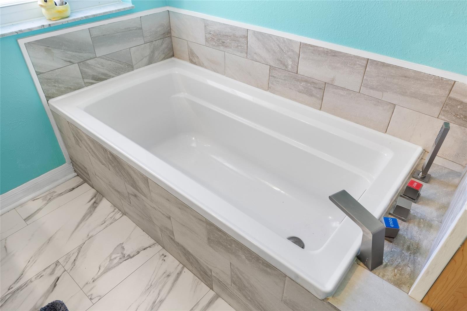 Primary bathroom garden tub.  Just imagine taking a soothing bubble bath in this lovely tub. There is also a walk-in shower