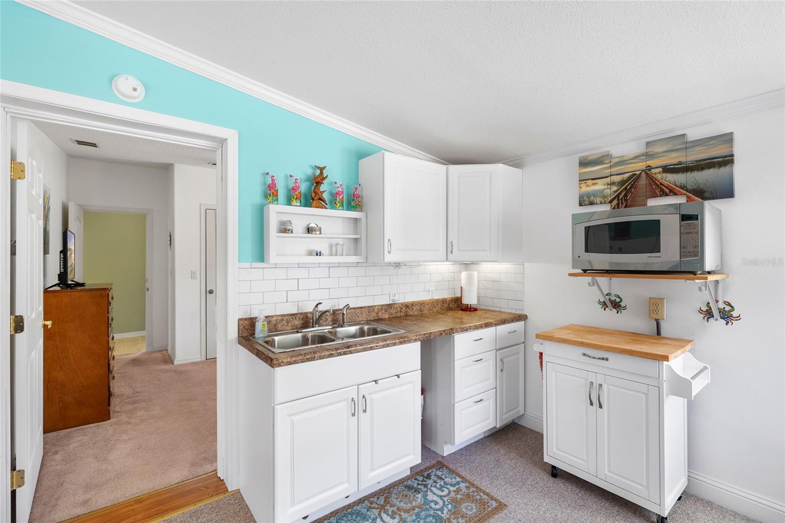 Guest room/In-law suite with kitchenette including full-sized appliances
