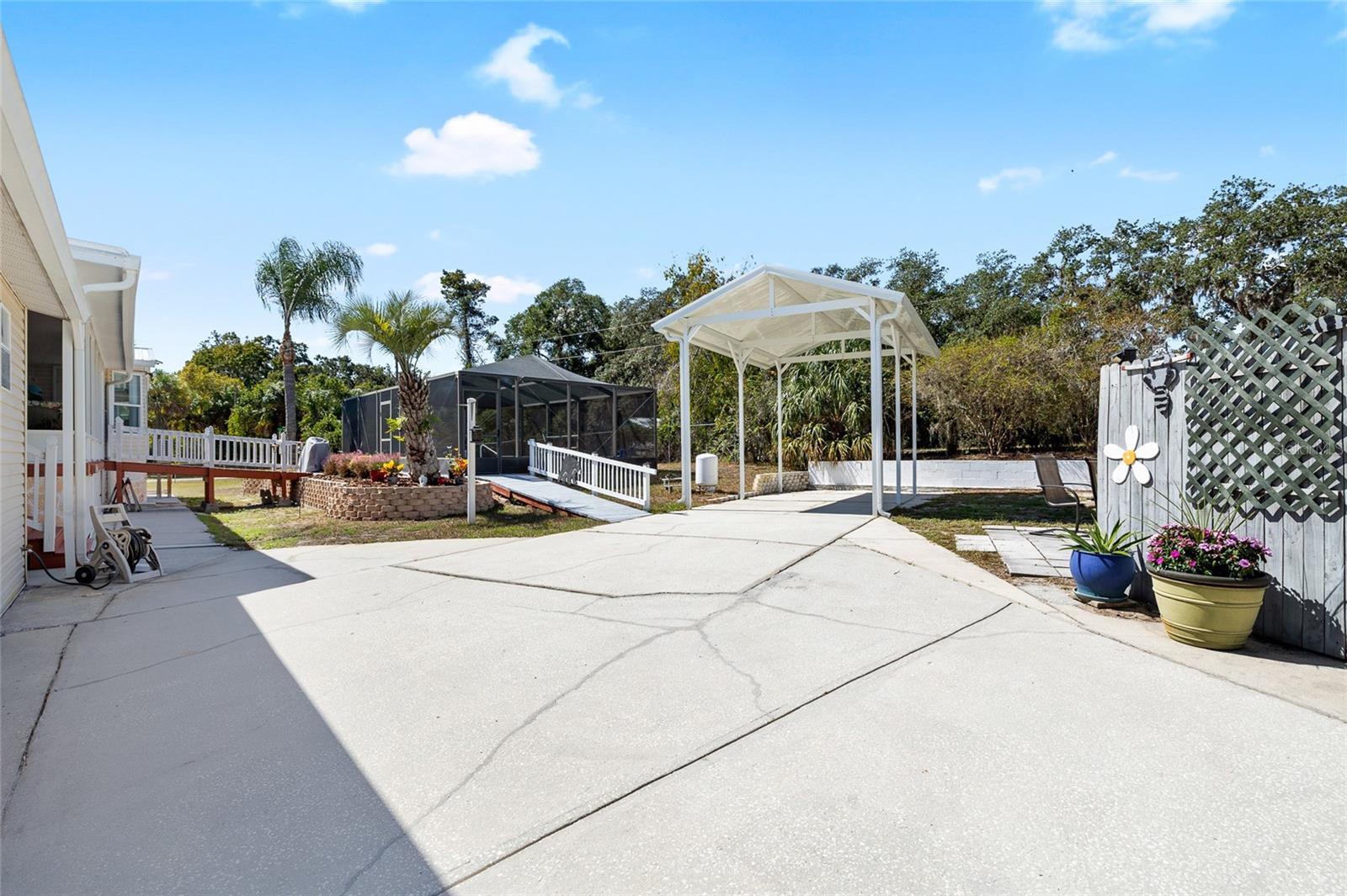 You'll appreciate all the parking this large property offers inside it's enclosed fence with remoted automatic gate including a covered RV parking with dump station /boat parking