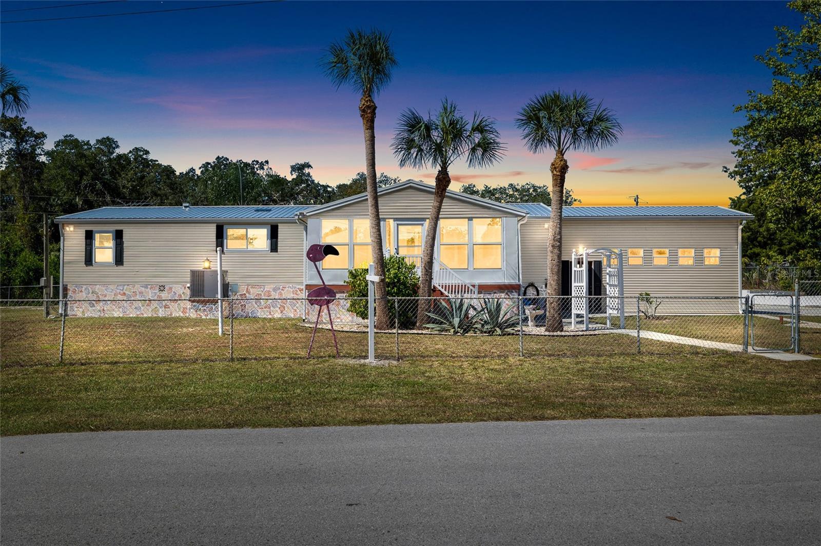 Look at this fabulous private double lot spacious, updated salt water pool home, with a gated property entrance with remote controlled automatic gate entry, tons of parking,  a 3 car garage and covered RV parking spot with dump station, plenty of parking with garden, storage galore, firepit area, screened patio & porch and more!