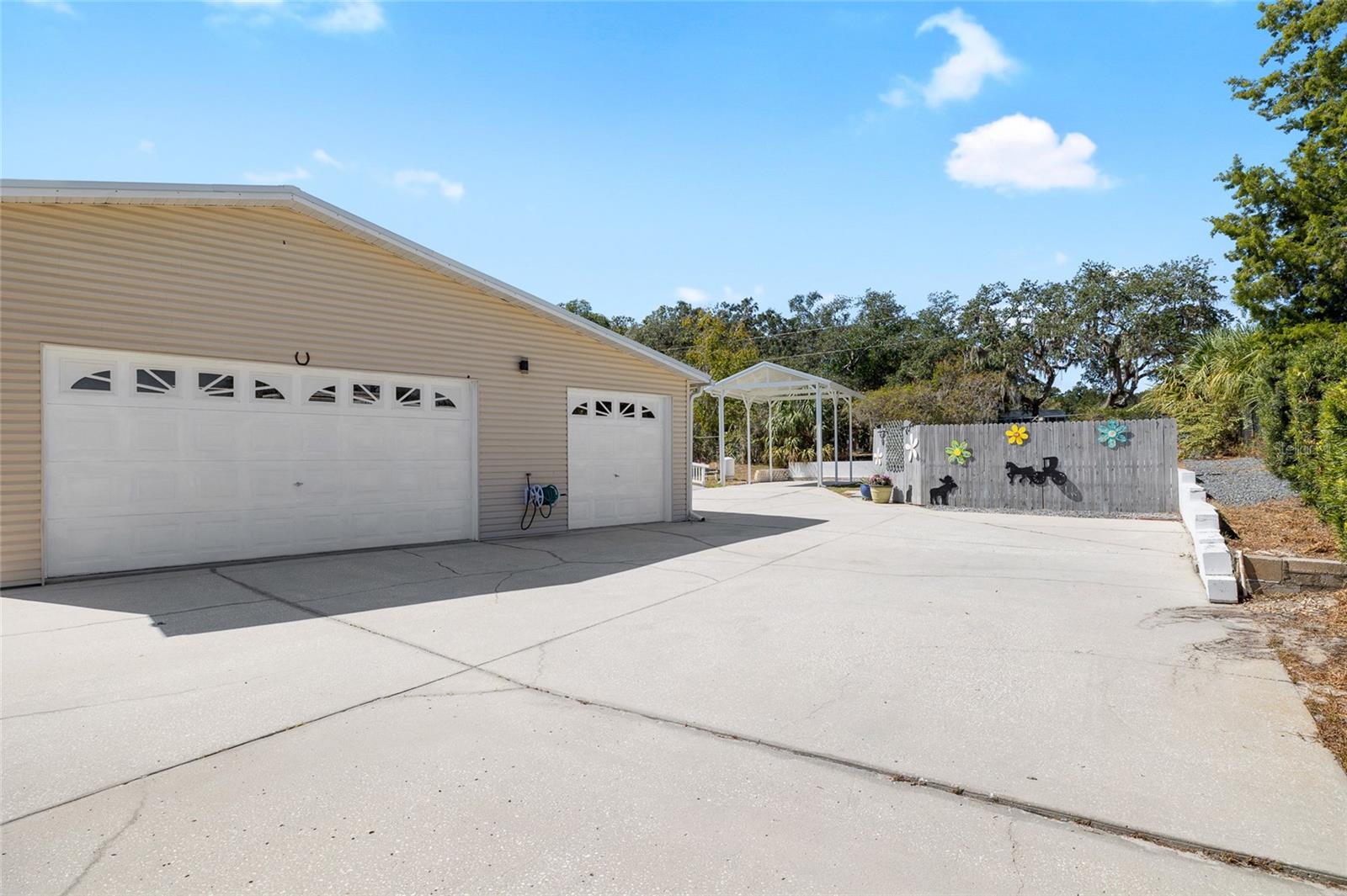 3 car garage with a small workshop area,  & a full bathroom.  There is also crawlspace under this home with a complete cement slab below the home