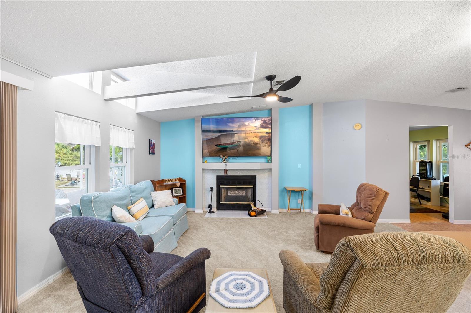 Living room with fireplace, ceiling fan