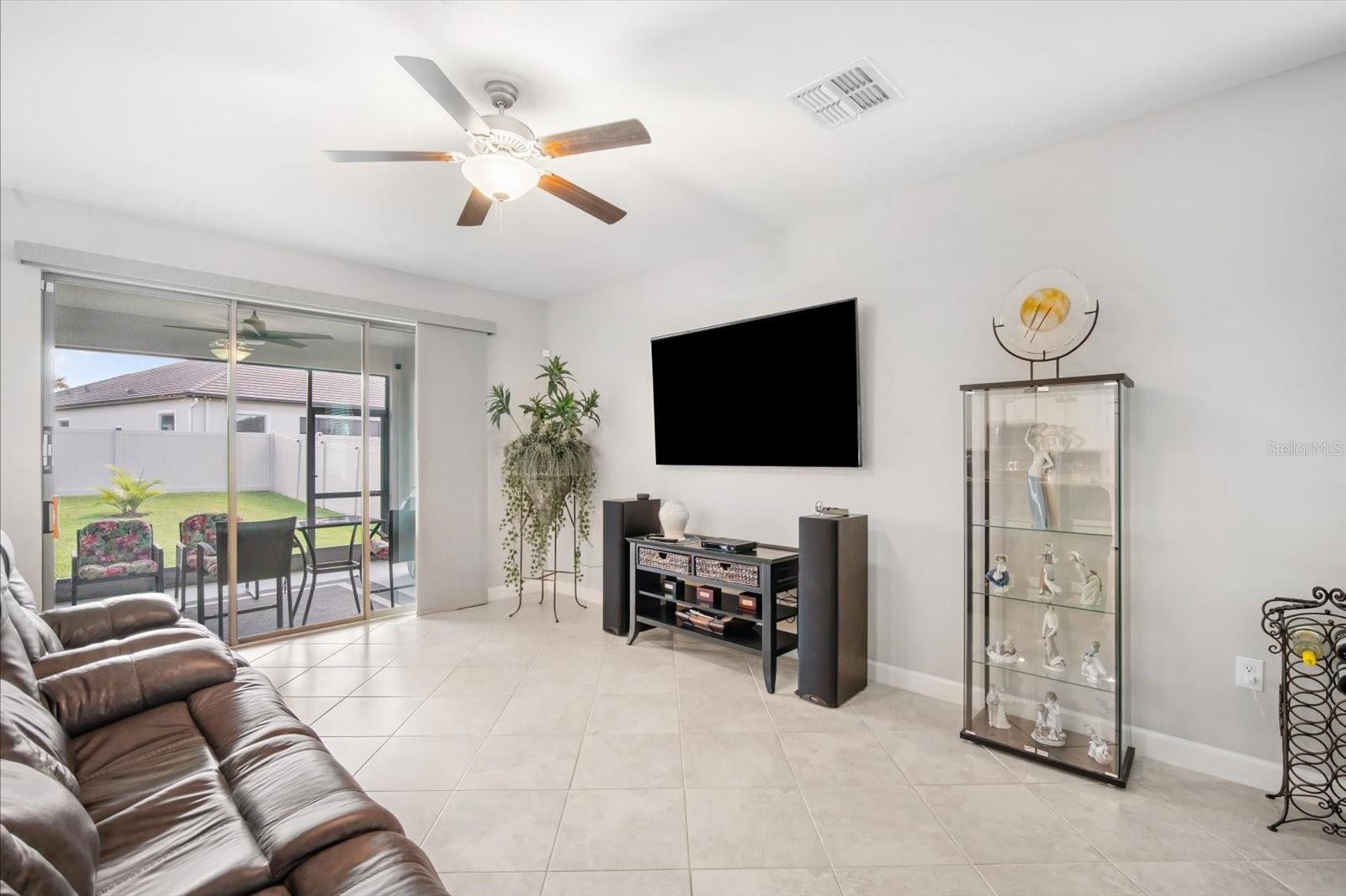 Living room with view of large slider and backyard