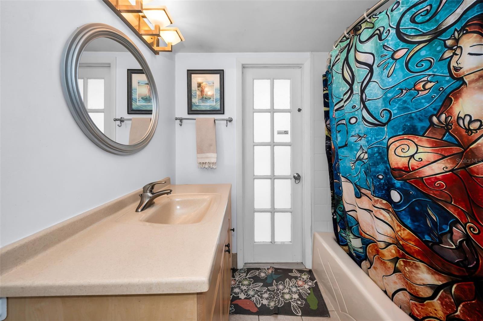 Bath two with door to pool area