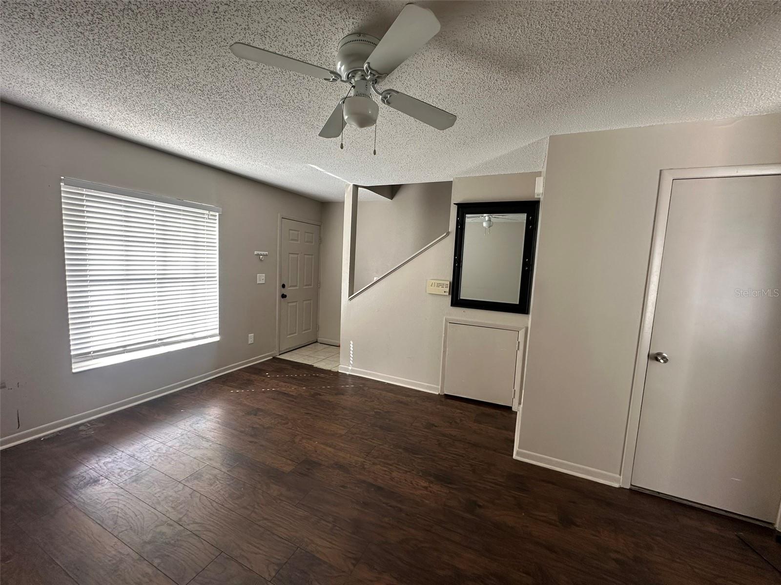 Living room with Celing Fan and Natural Light!