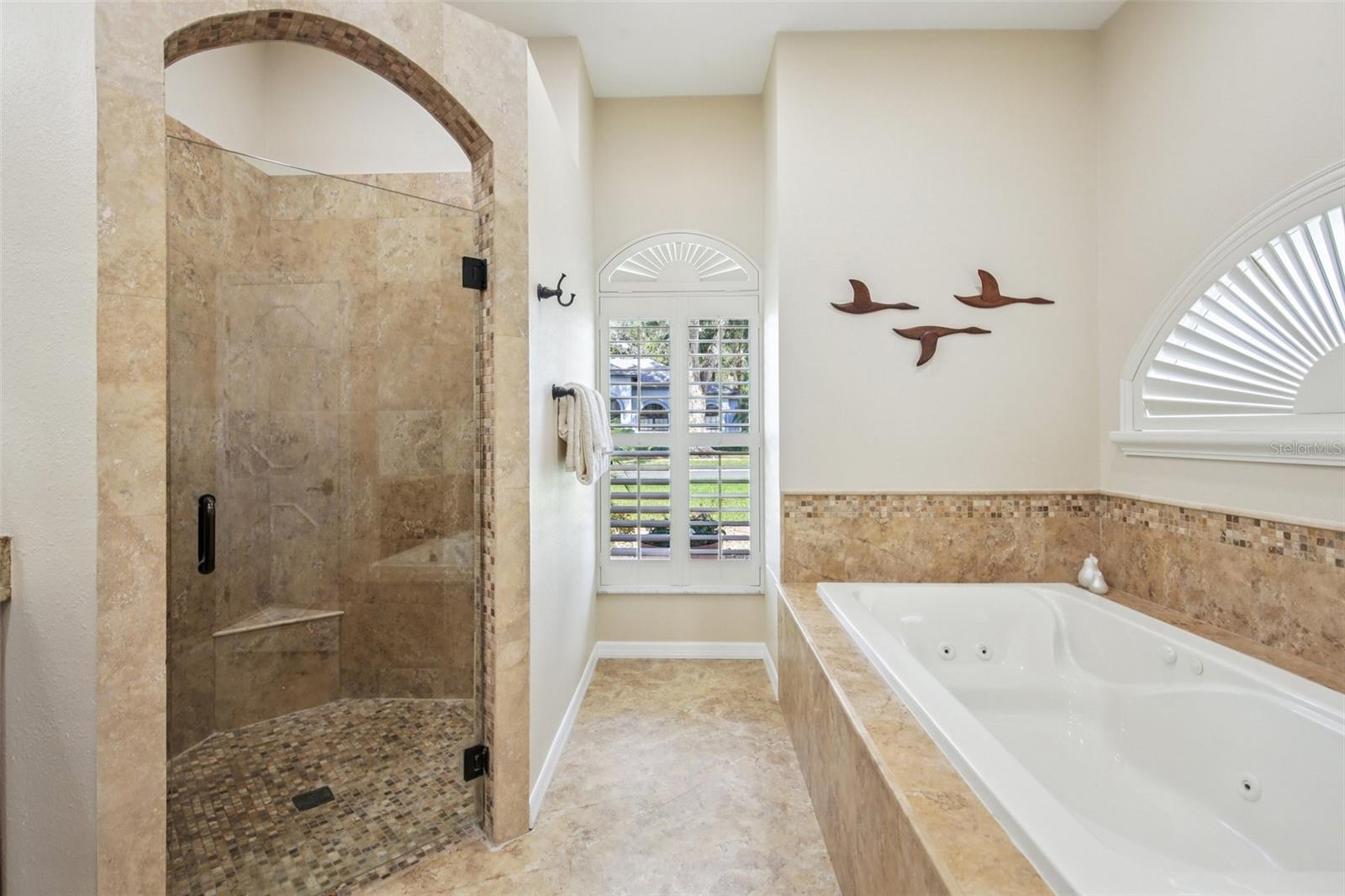 WALK IN SHOWER AND SEPARATE SOAKING TUB IN PRIMARY BRINGS ALL THE LUXURY
