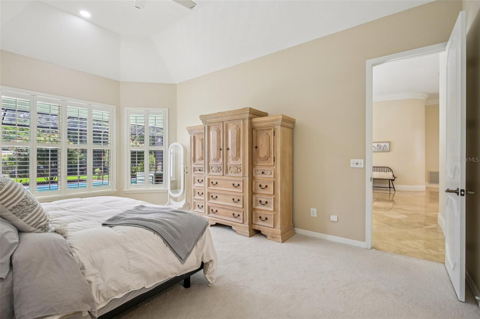 PRIMARY BEDROOM OVERLOOKS THE POOL