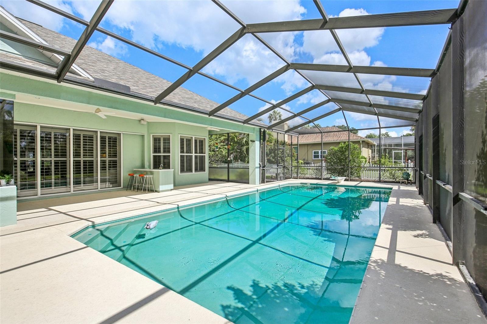 ENJOY FLORIDA LIVING! SCREENED POOL WITH COVERED LANAI PROVIDES A GREAT WEEKEND RETREAT!