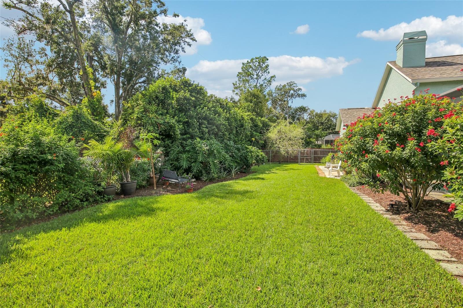 BEAUTIFUL BACKYARD WITH NATURAL BARRIER PROVIDES ADDITIONAL PRIVACY