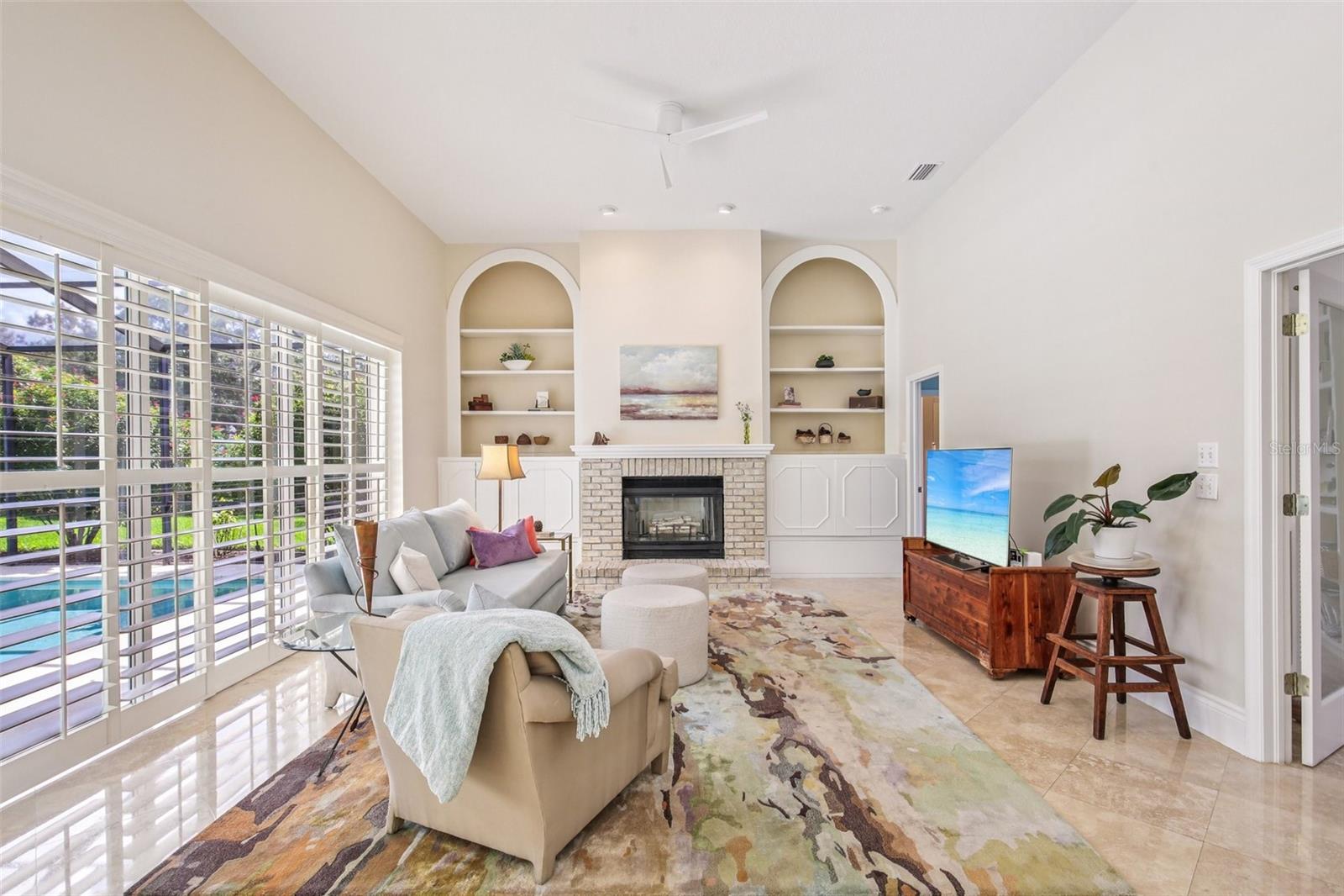 BIG SLIDERS ALLOW ALL THE NATURAL LIGHTING IN THE FAMILY ROOM