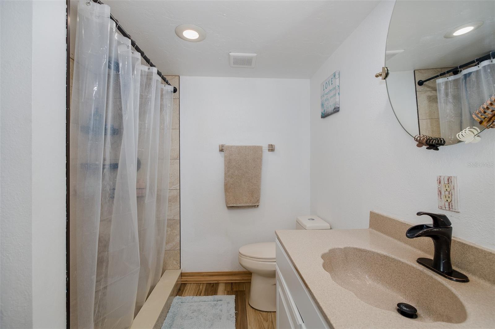 Ensuite primary bathroom with large, tiled shower