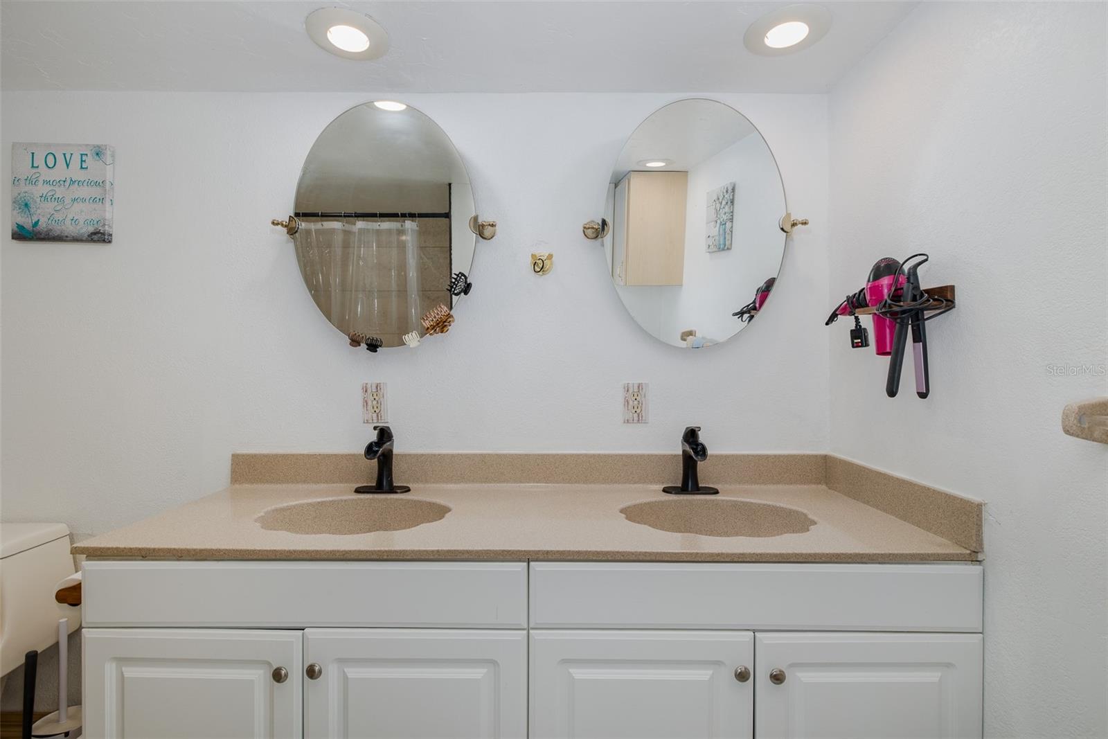 Double sinks and cabinetry in primary bathroom
