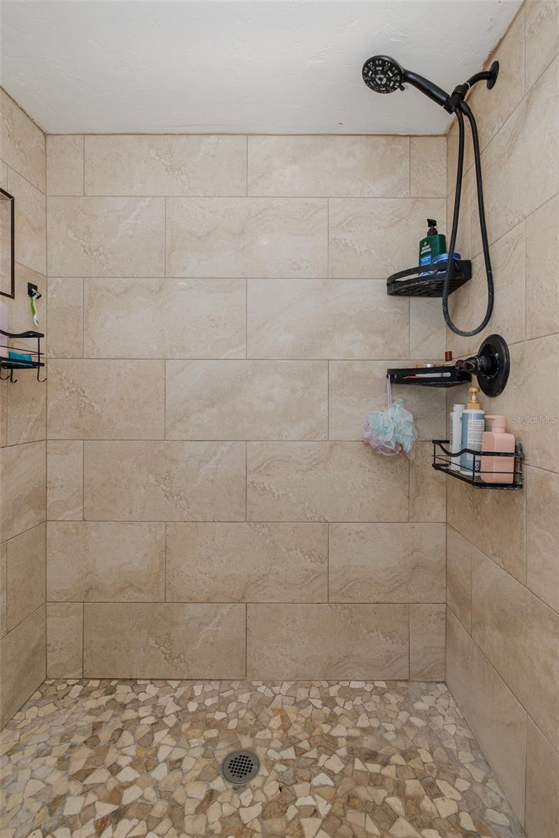 Large, tiled shower off primary bedroom
