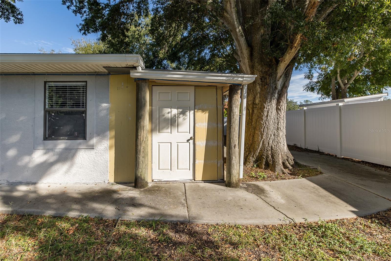 Back entrance to garage and storage rooms