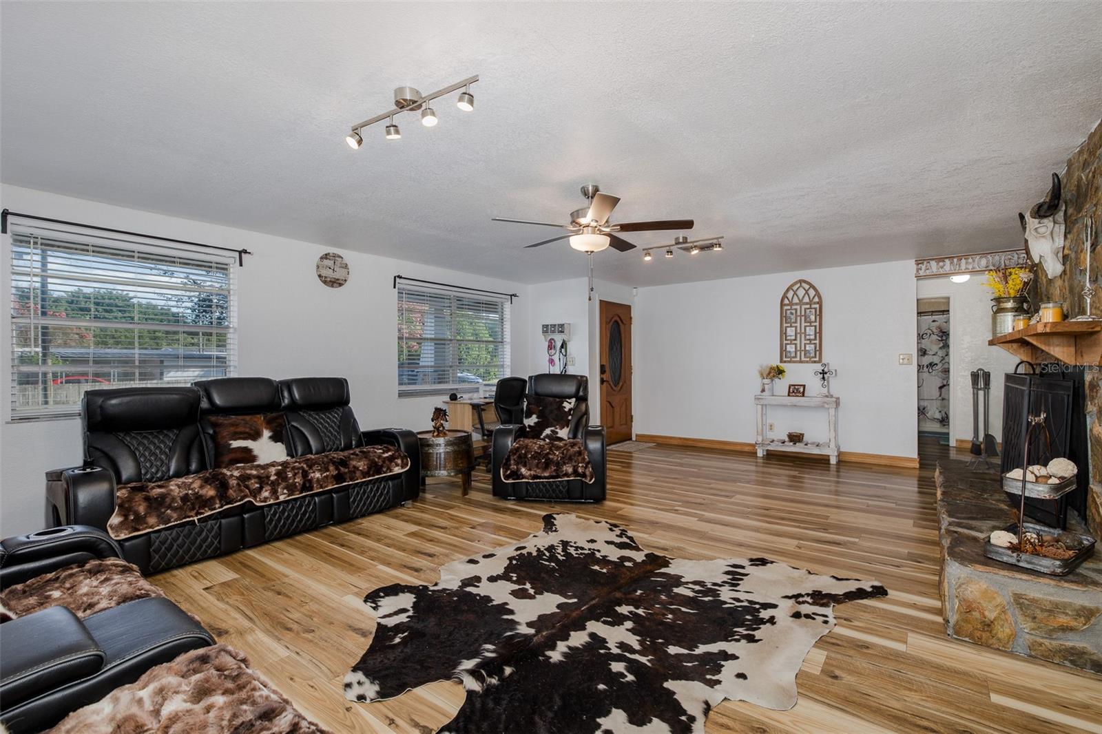 Spacious living room with stone fireplace