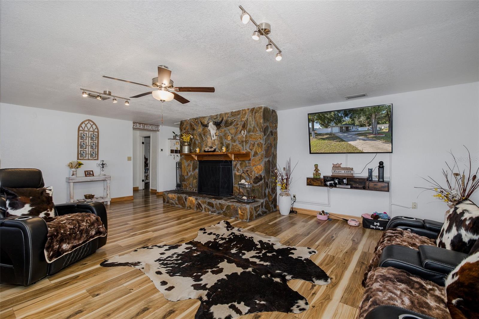 Spacious living room with stone fireplace
