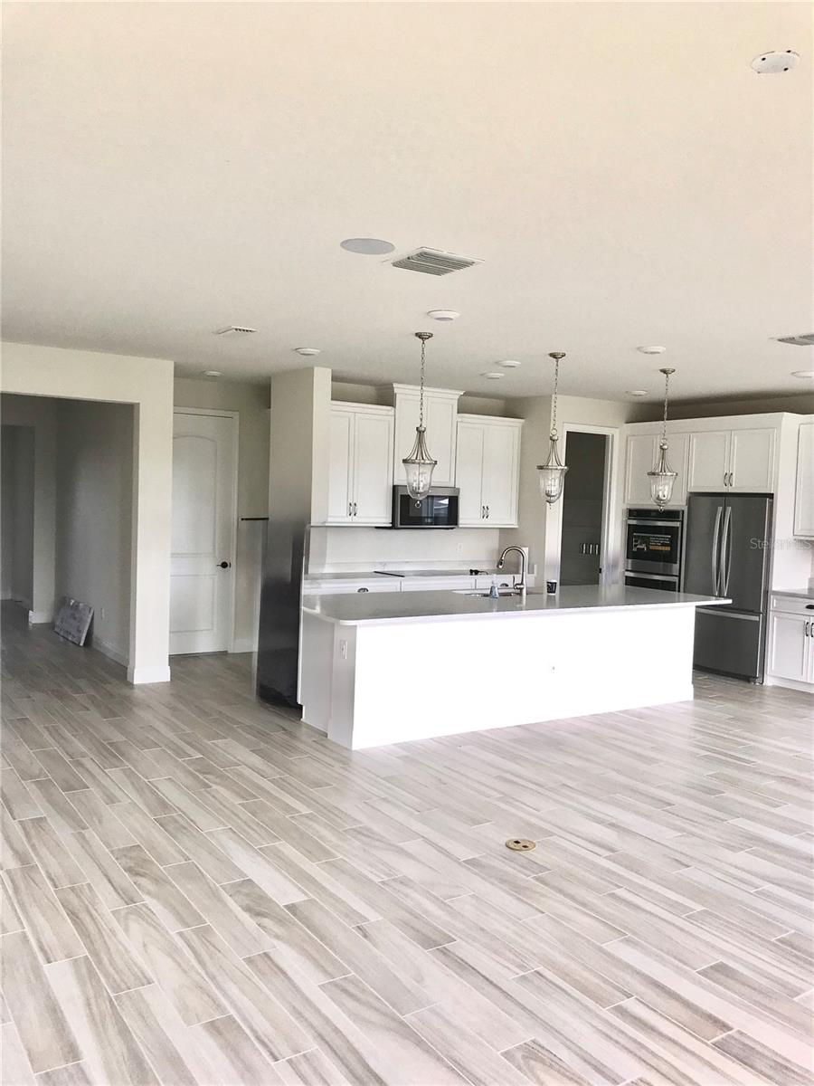 Unfurnished Kitchen and Great  Room (living room) with in floor outlets