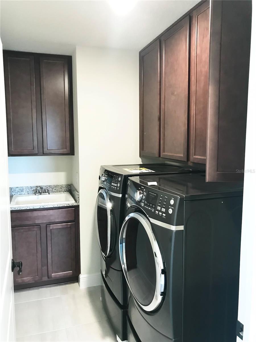 Laundry room with cabinets and deep washing sink
