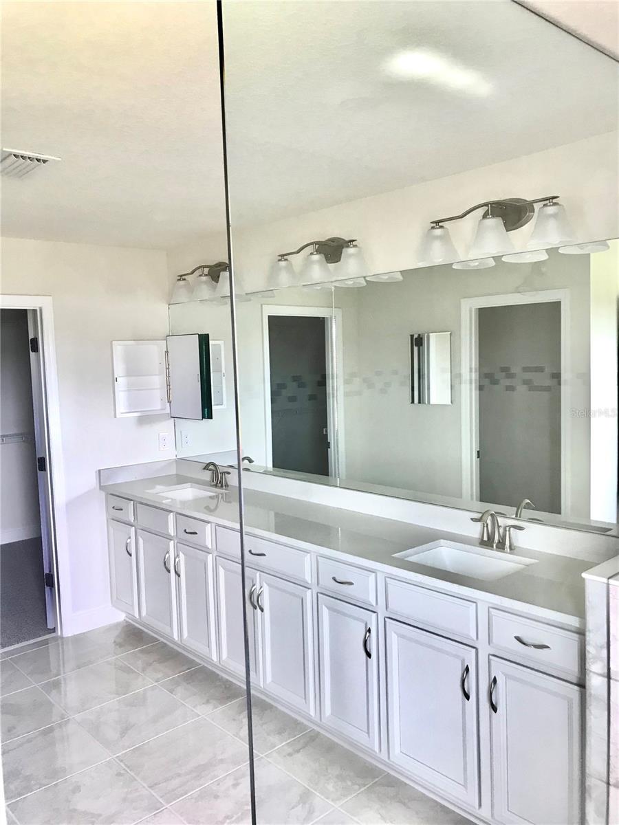 Double sink and plenty of cabinet space in Master Bathroom / 1 of 2 Medicine Cabinets