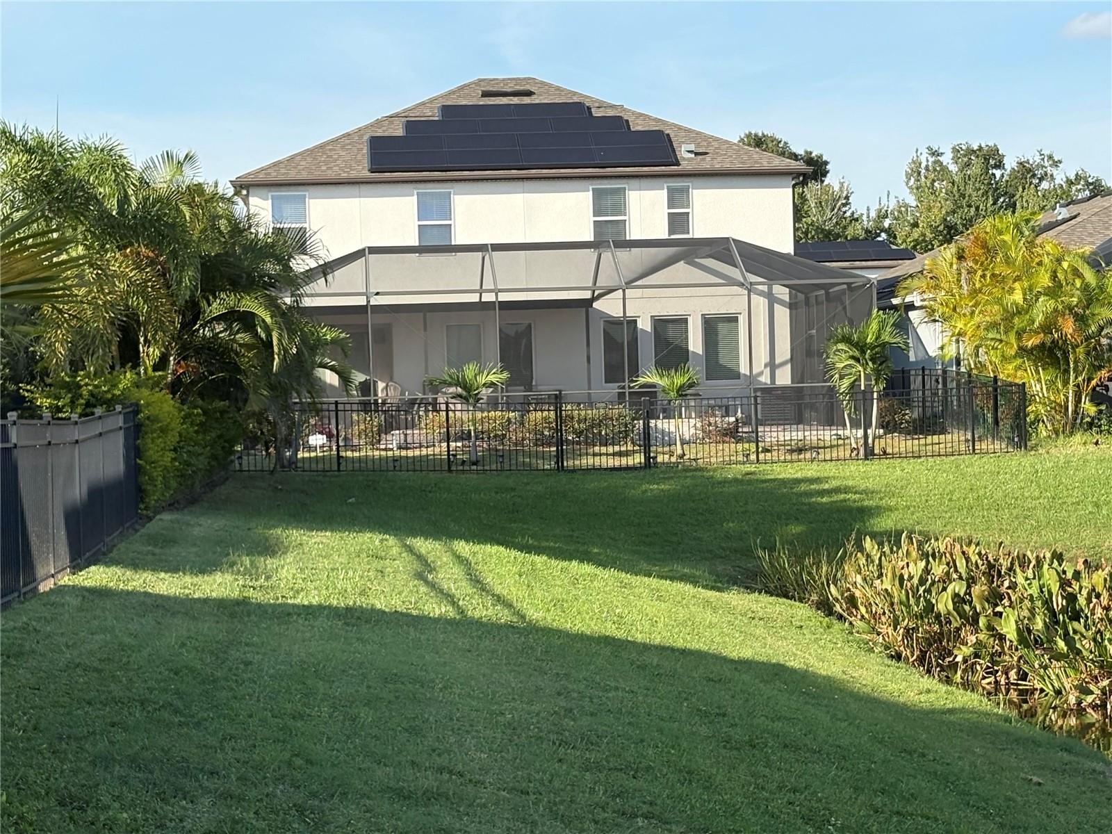 Backyard view of house close to the pond area