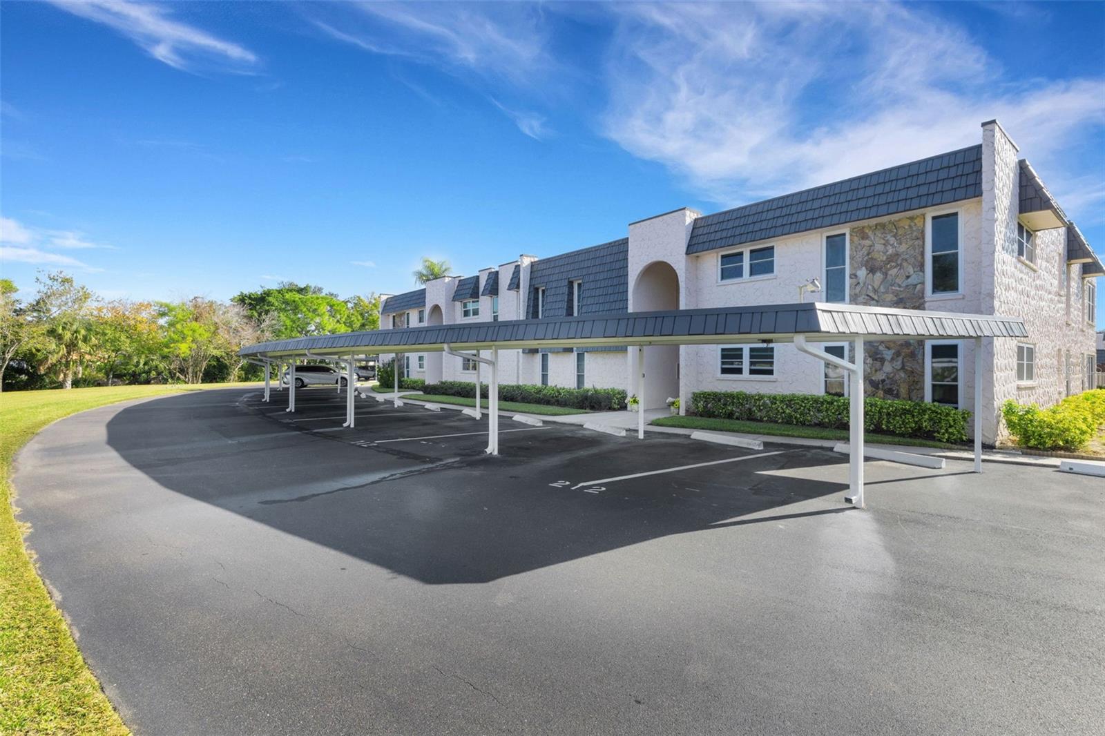 Front of Building Showing Front of End Unit and 2 Covered Parking Spaces