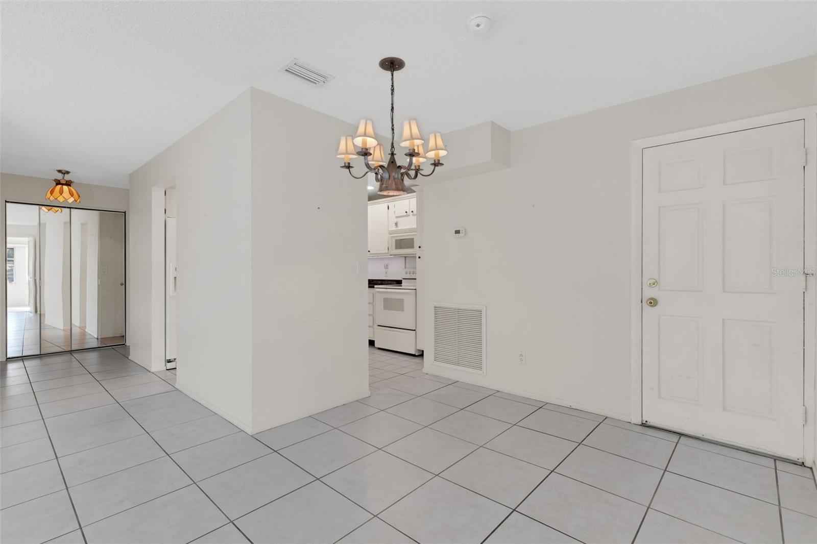 Dining Area With Pedestrian Door to Stairs to Walkway to Pool and Clubhouse