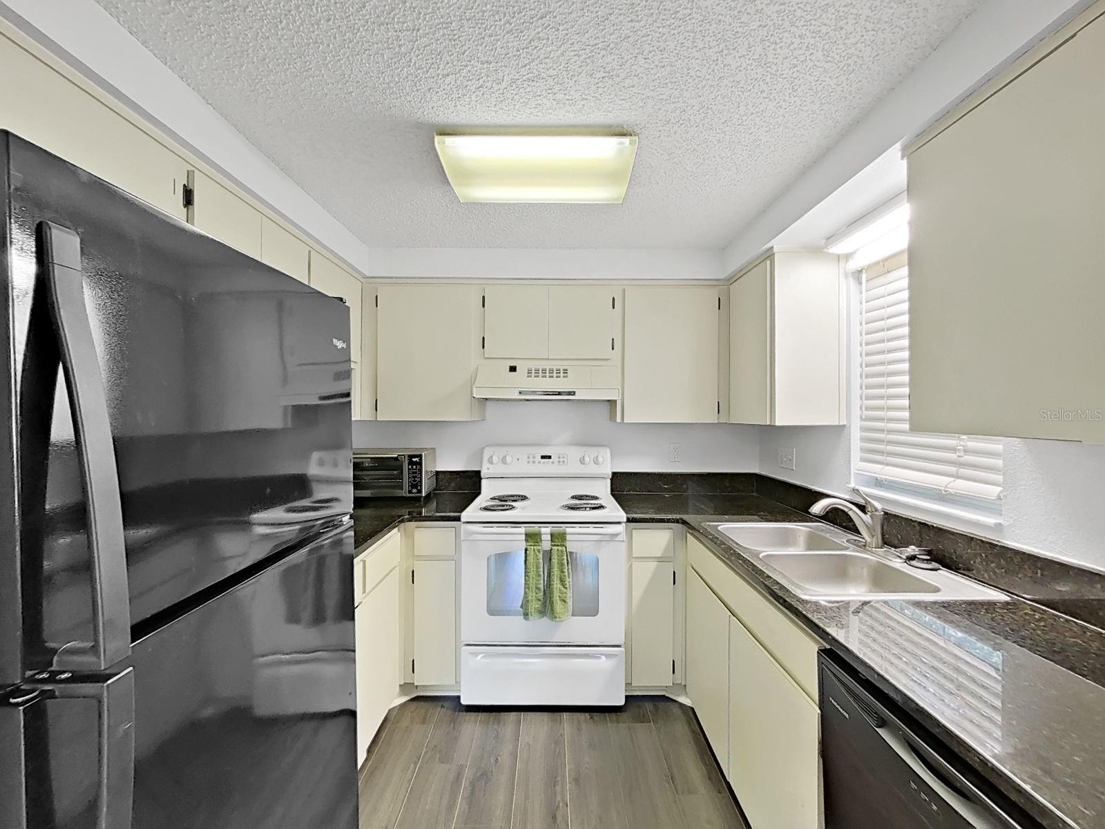 Everything you may need with upper and lower cabinets and granite counters!