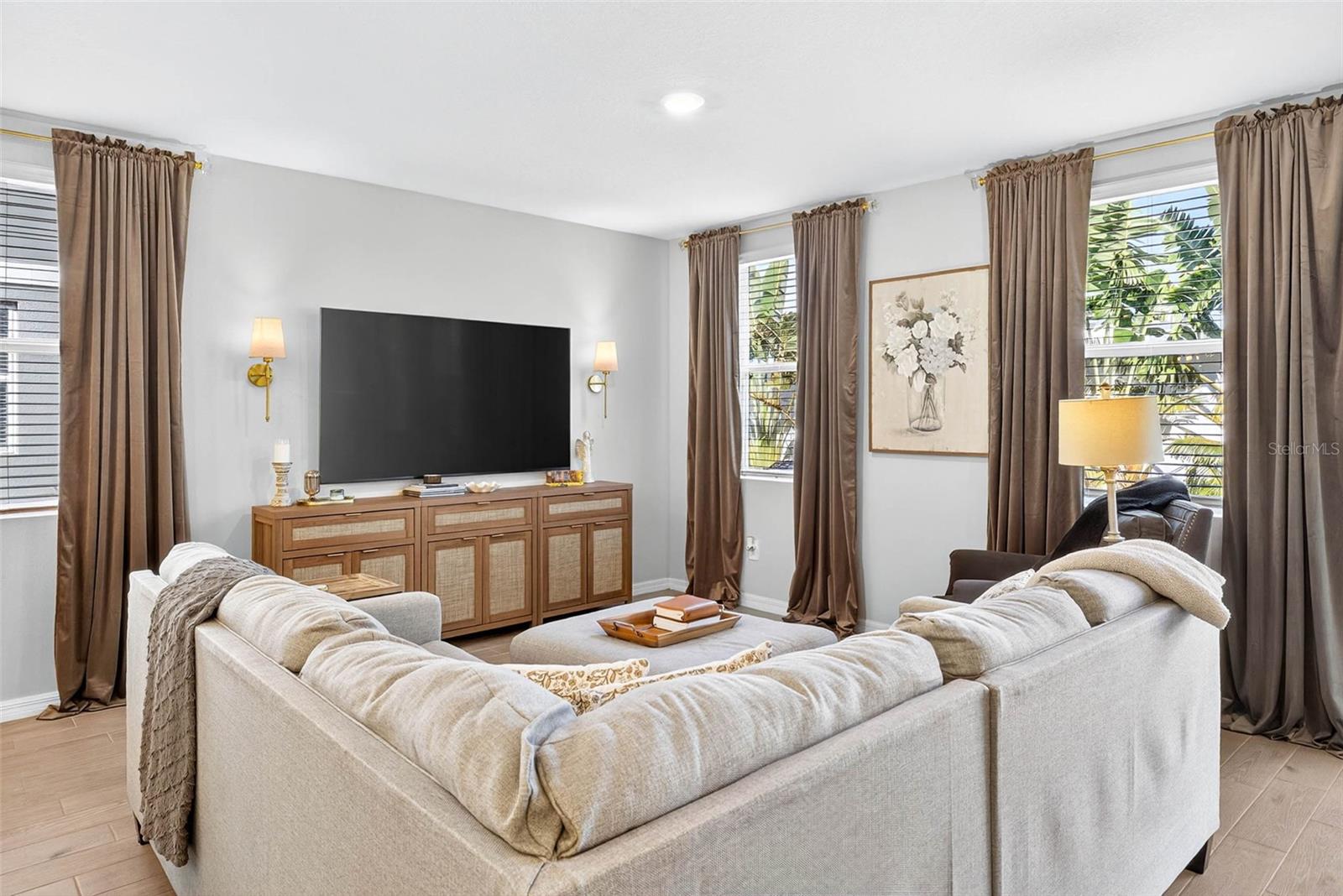 window treatments frame the windows for a stunning floor to ceiling look.