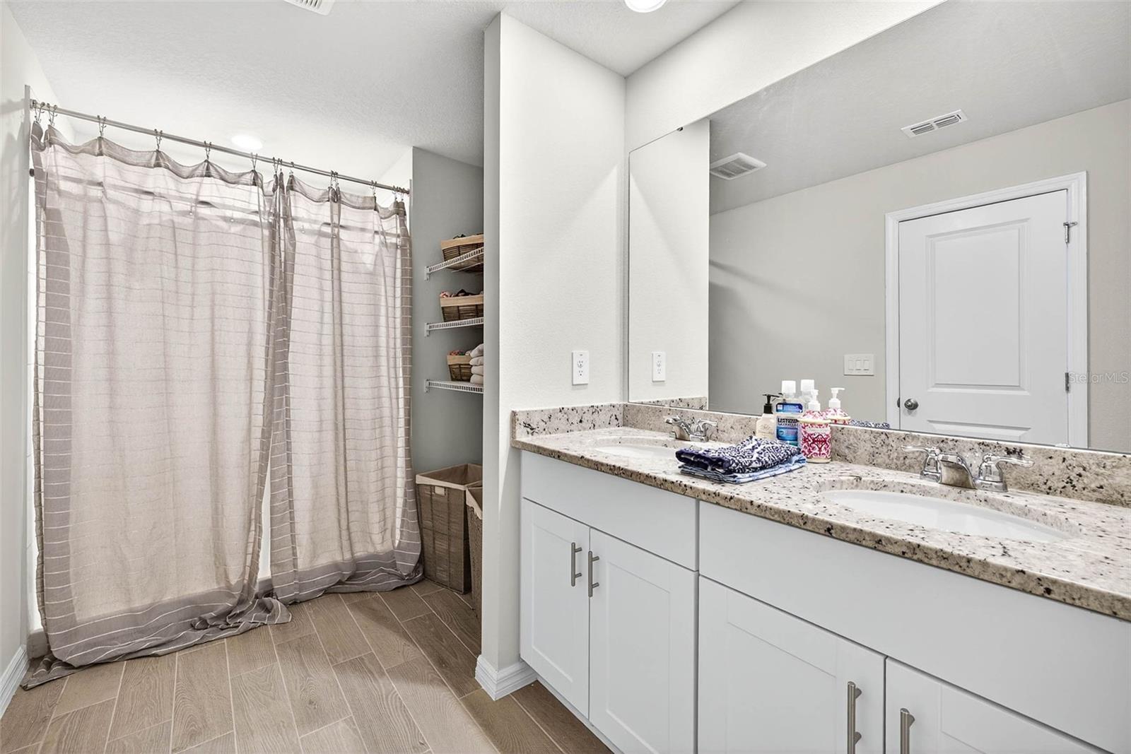 Primary suite with dual sinks, separate water closet.