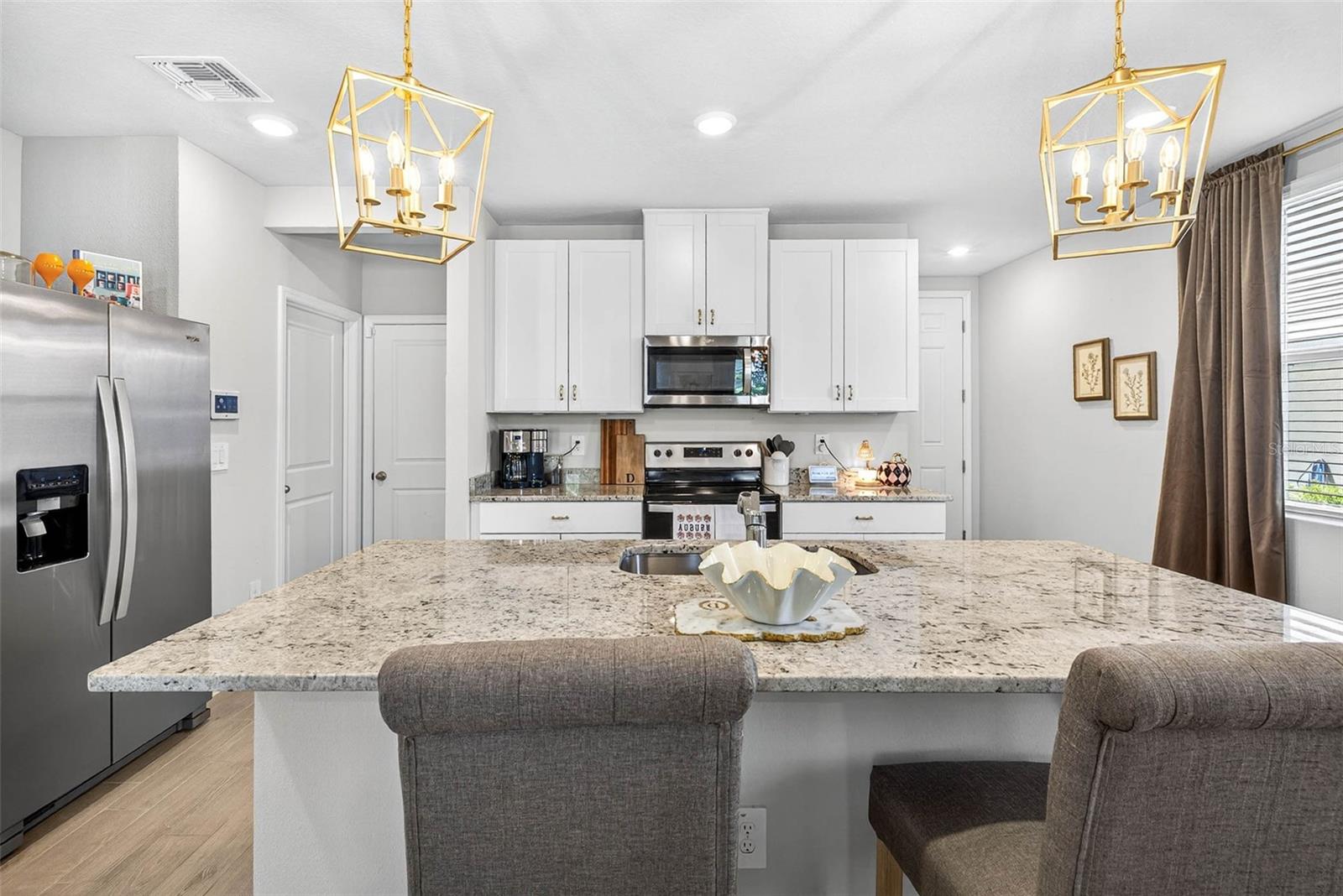 Beautiful upgraded overhead light fixtures, stainless steel appliances, half bath and garage access.
