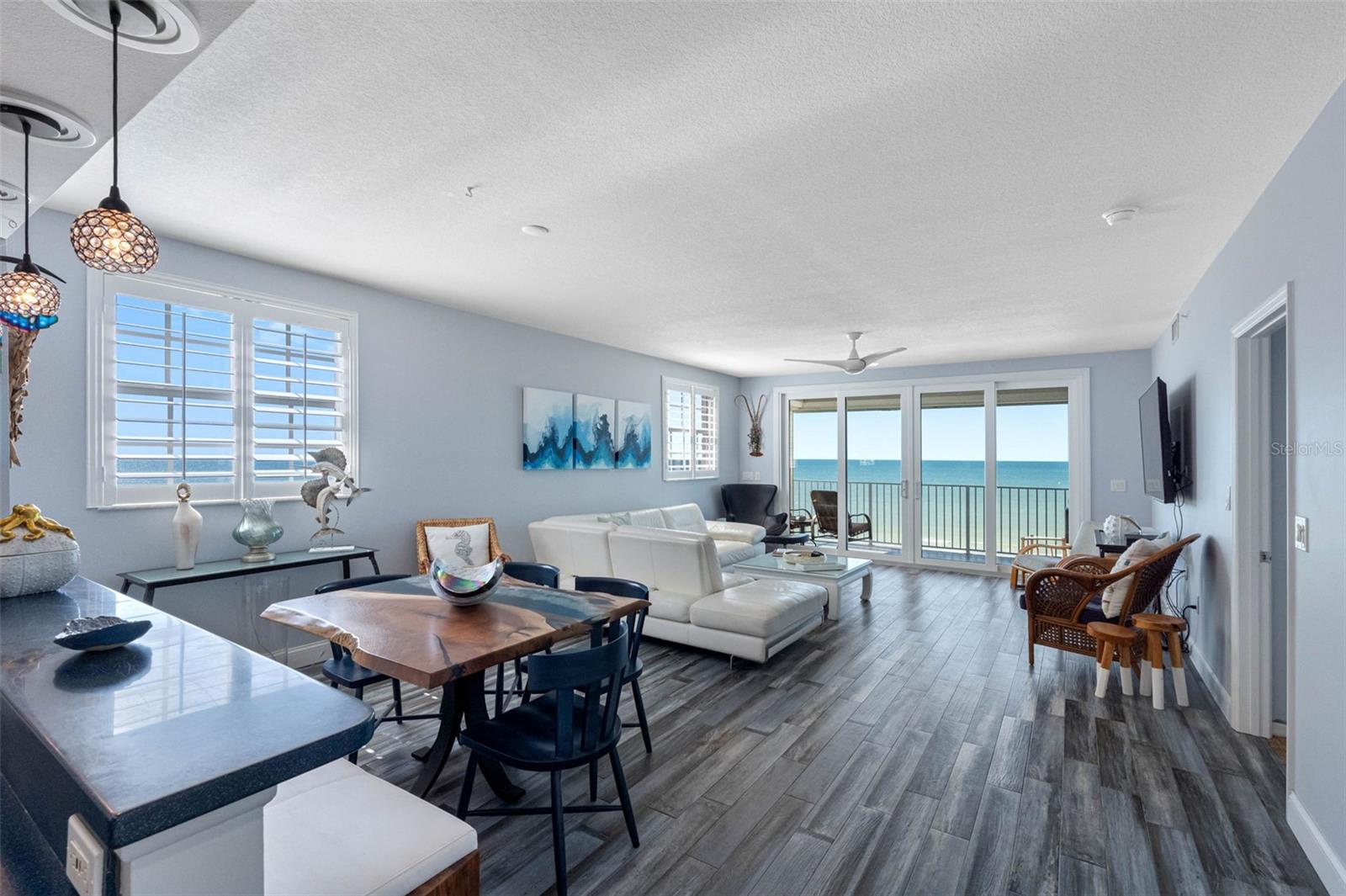 ... Money Shot From Kitchen Area Thru Great Room To Balcony Sliders. The Blue Corian Countertops Mingle With The Gulf Water Hues.