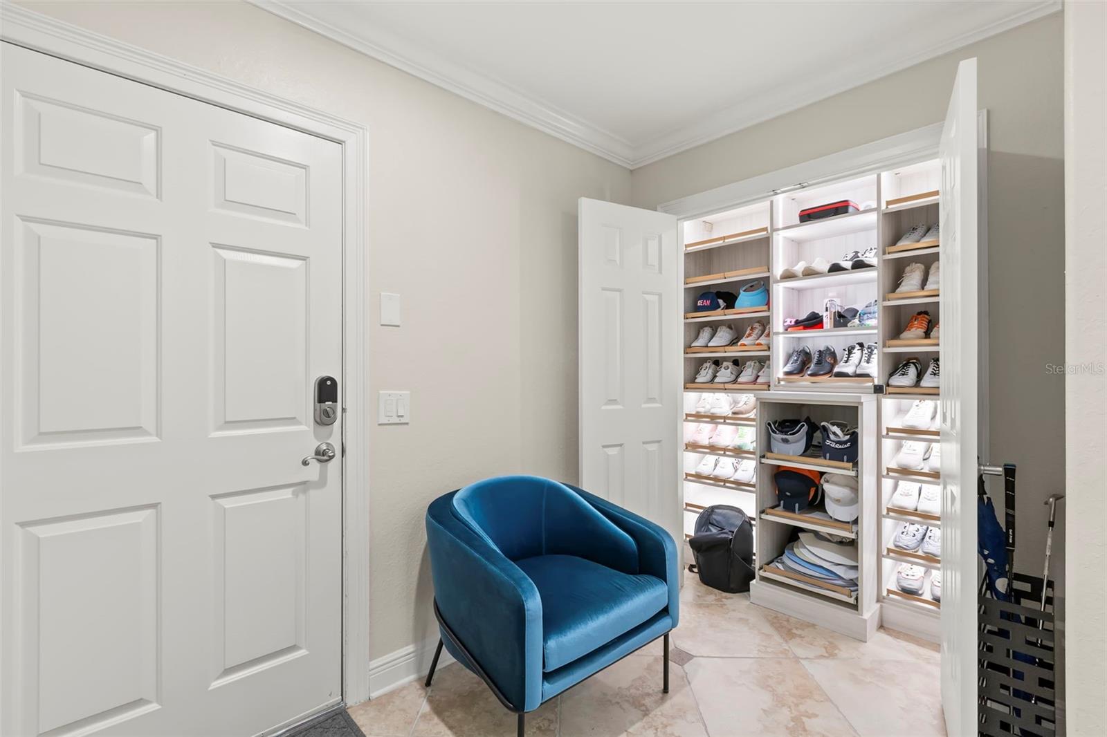 Entry-way from garage with custom closet space.