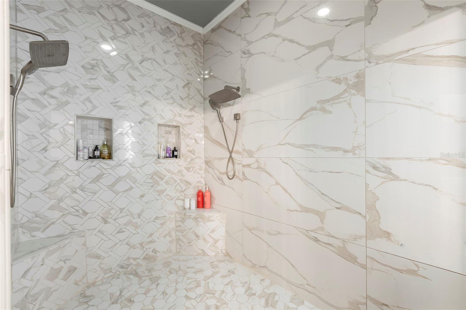 Oversized walk-in shower with multiple heads.