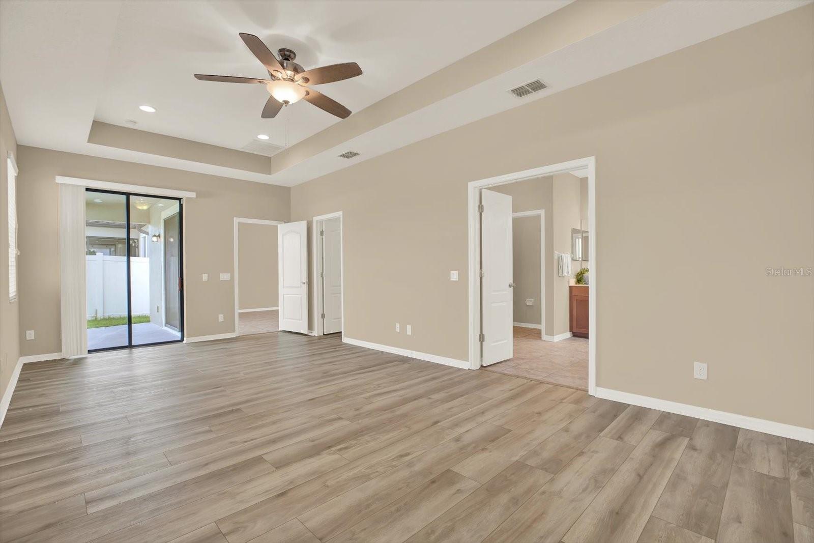 Primary Bedroom with sliding glass doors to enclosed patio