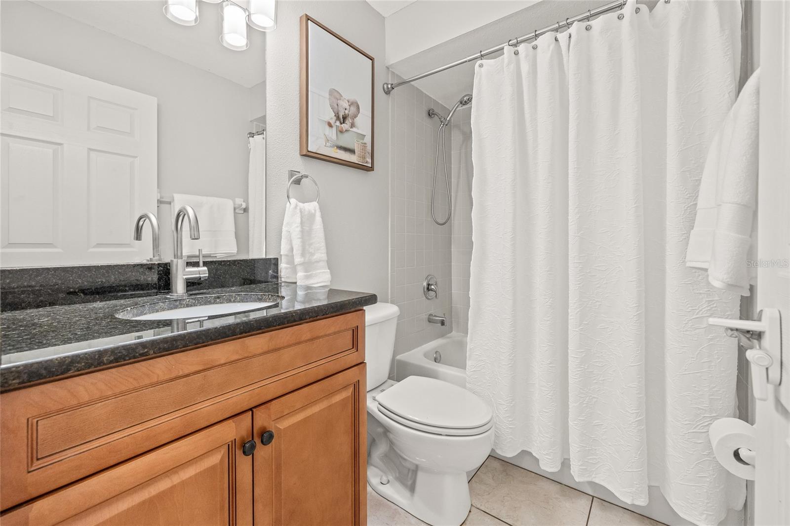 Hallway full bathroom with tub and shower.