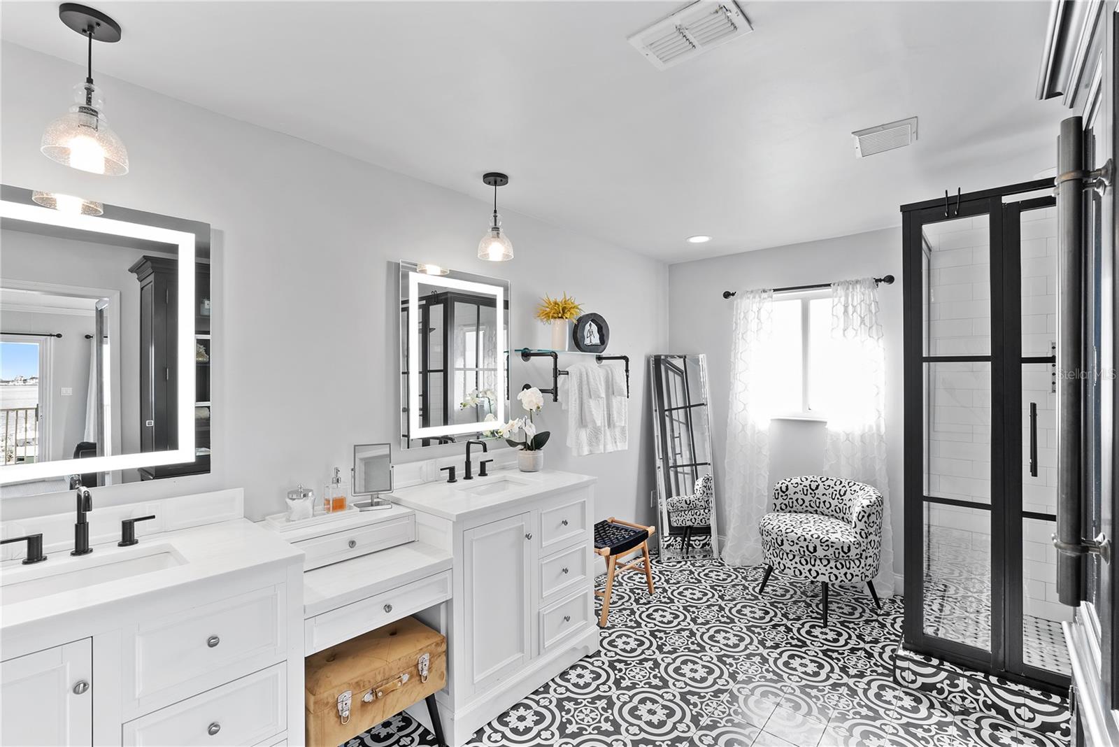 Spa-style bath with dual vanities, and walk-in shower