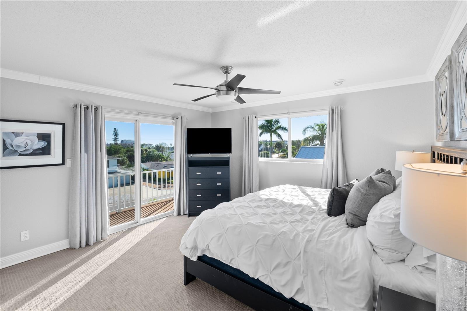 Guest room with TV and balcony.