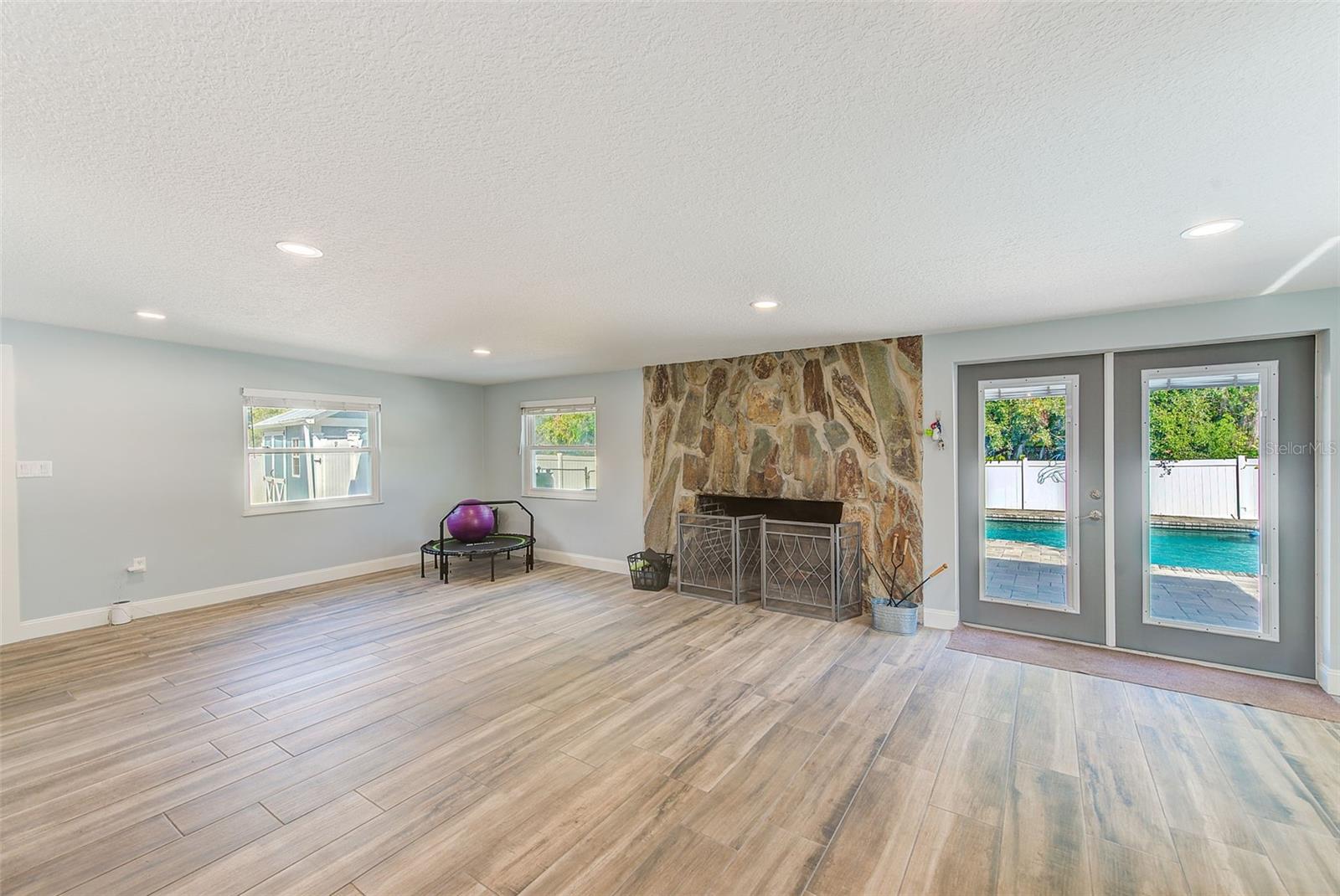 French doors with built in blinds open to refreshing pool