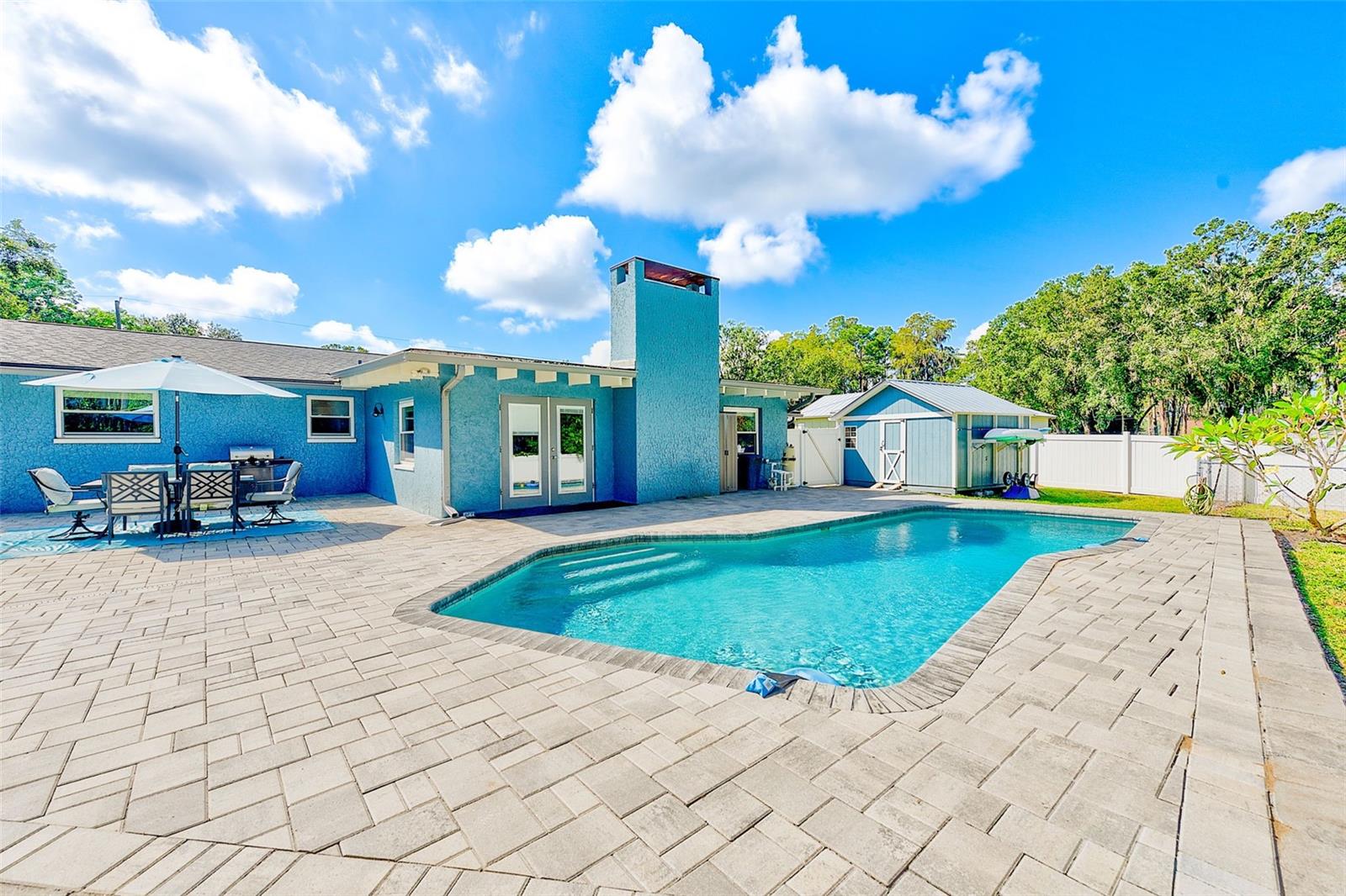 Expansive paver patio with dinning area and room for a custom outdoor kitchen