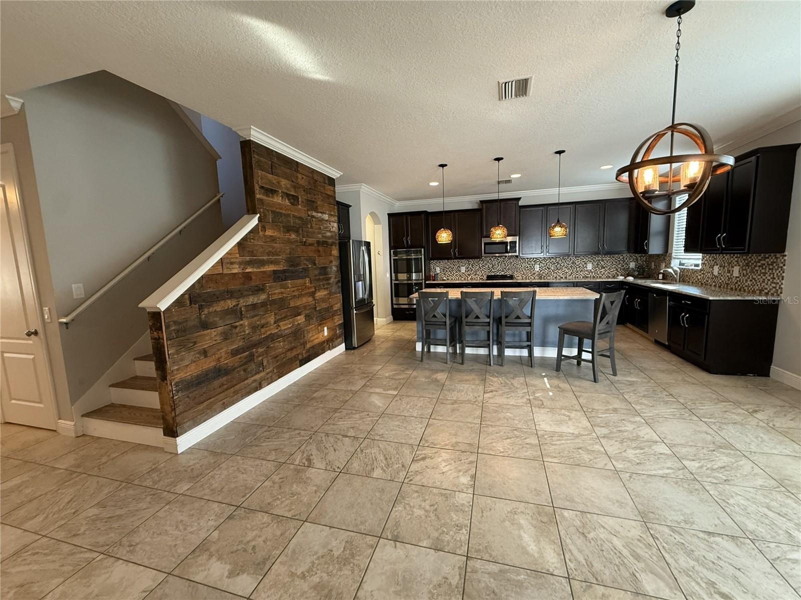 View of Stairs + Kitchen