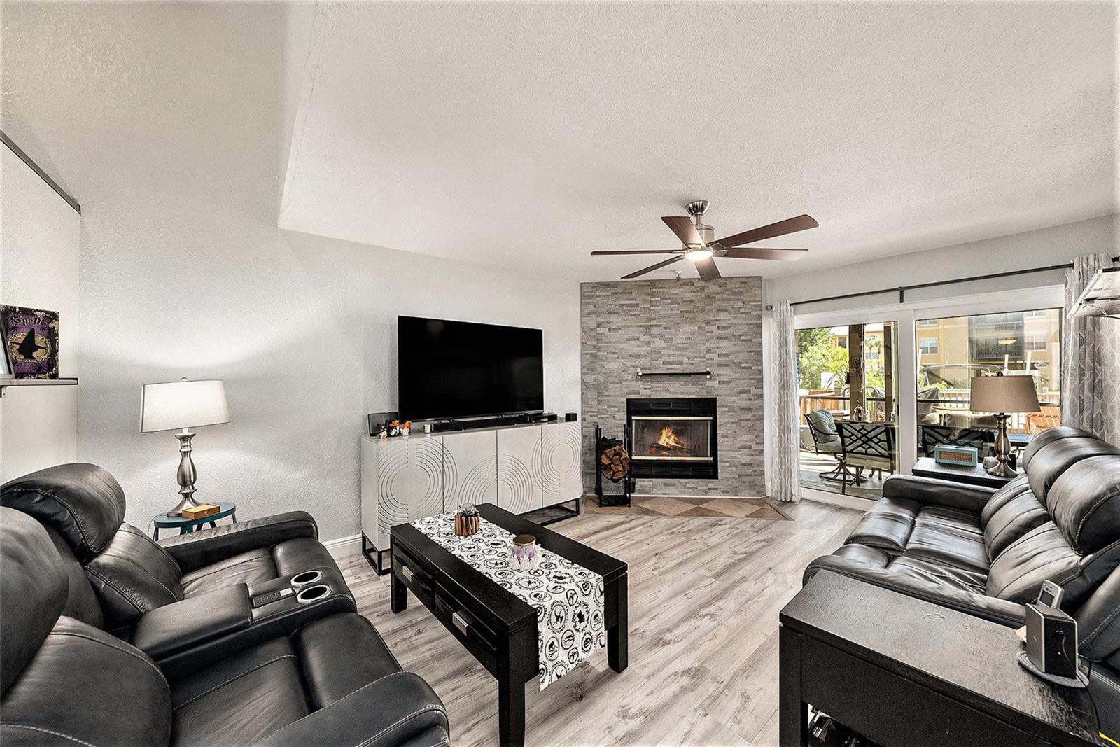 Family room with wood burning fireplace overlooking water