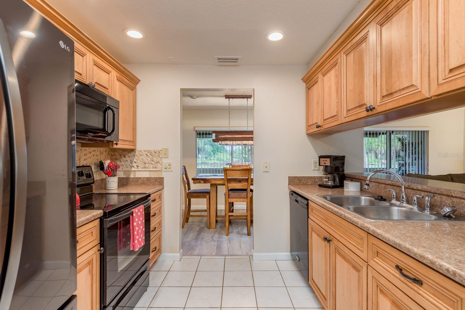 Nice wood cabinets and nice appliances.