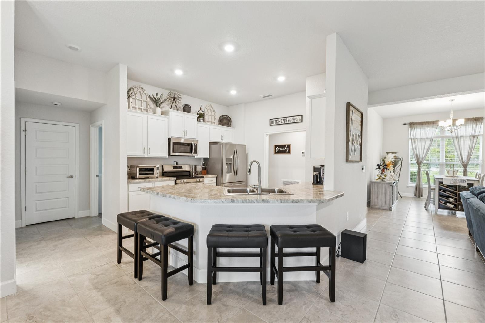 Kitchen with bar seating and views of the living room.