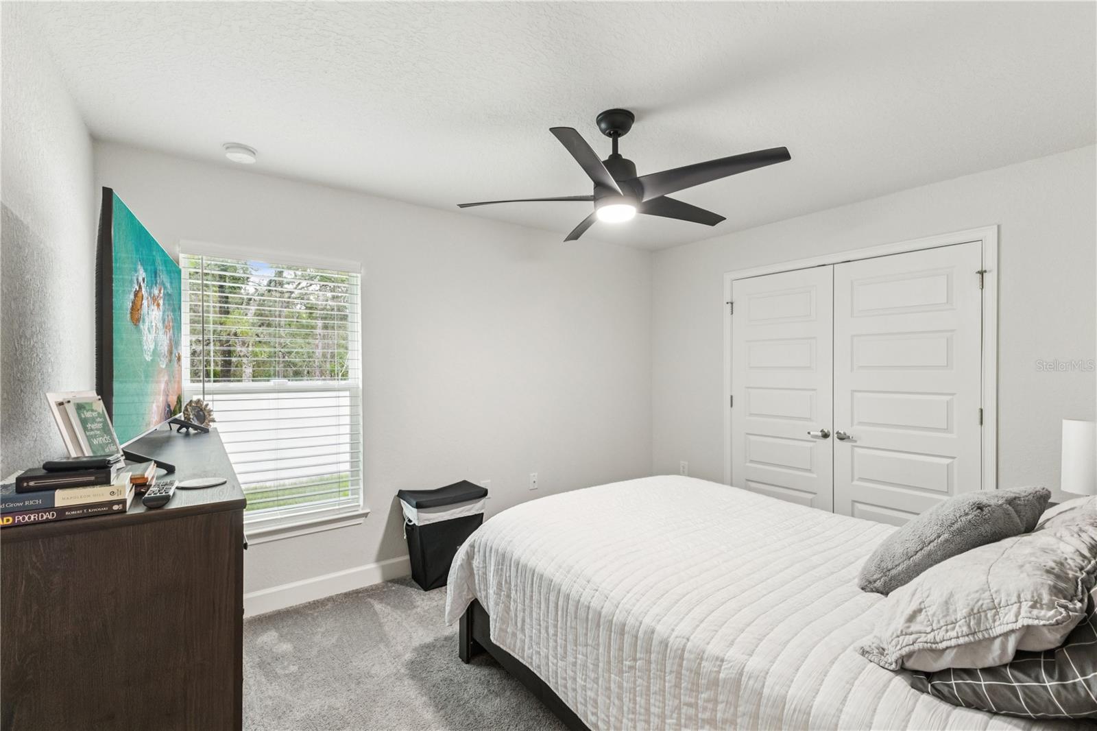 Reasonable size guest bedroom with its own unique view of the home exterior.