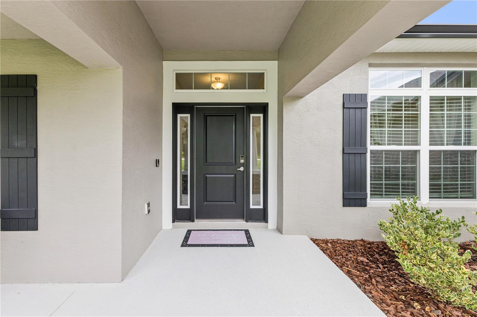 Front porch featuring doorbell camera and large covered patio for planters and a morning coffee.