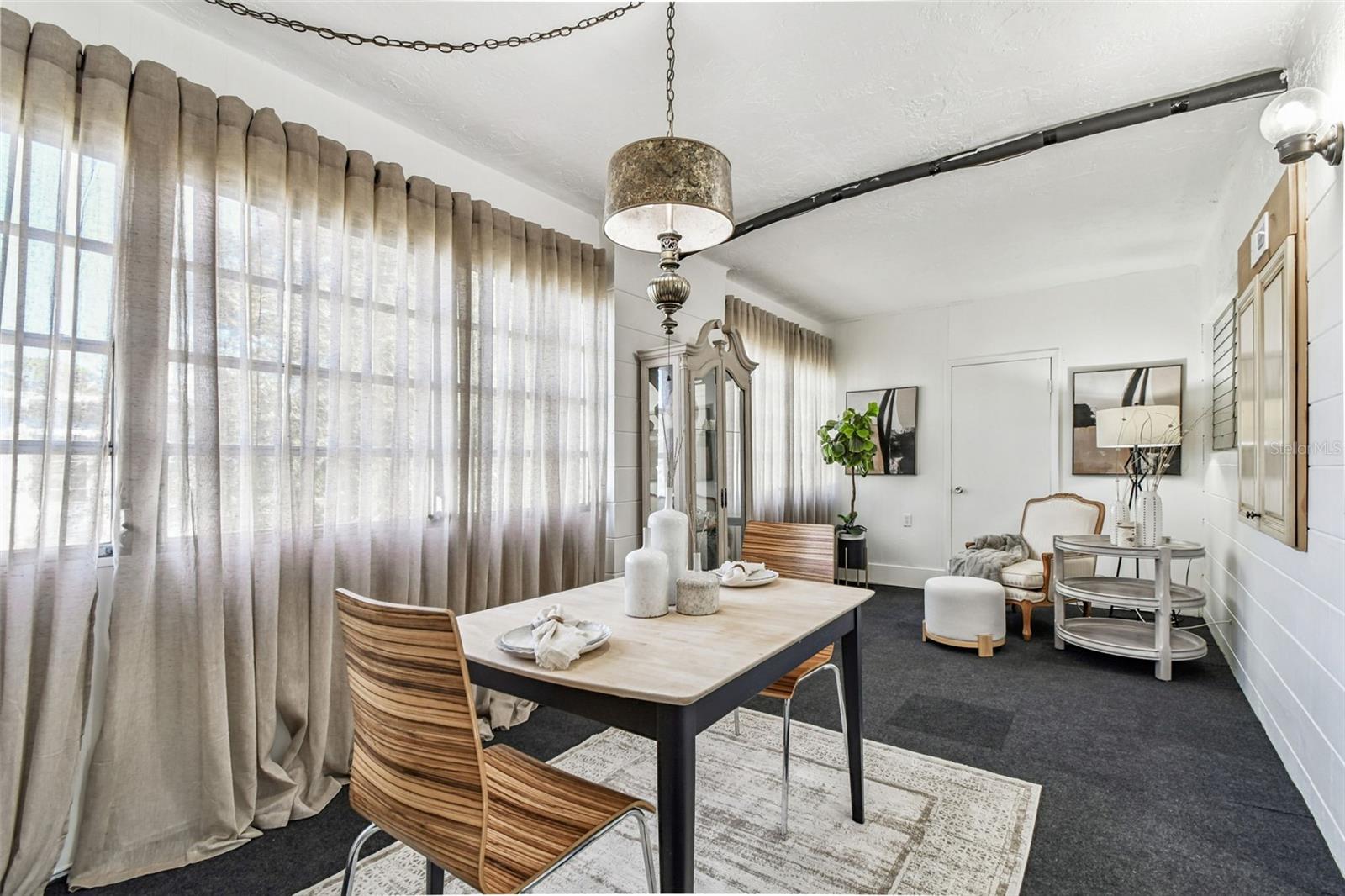 Florida room with a dining area and a sitting area, plus a large storage room at the end